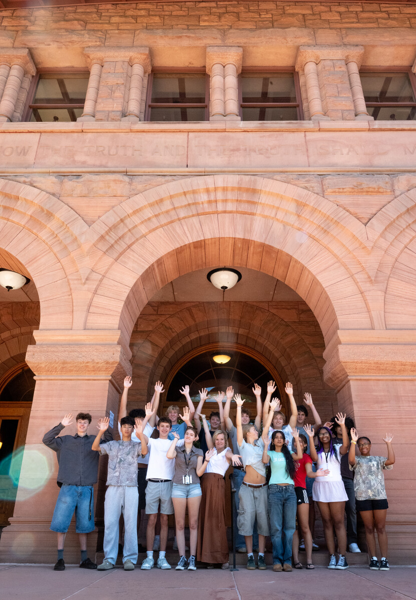 Students posing in front of Palmer Hall with their instructor